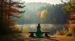© yevhen89 - Woman in green dress sitting on wooden bench by misty lake in an autumn forest early morning