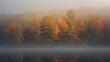 © The 2R Artificiality - Autumn trees surrounded by fog over a tranquil lake, seasonal change
