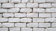 © The 2R Artificiality - Stack of aged, cracked and chipped white calcium silicate bricks closely packed together.