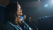 © FREEDOM - 映画館でスクリーンを見つめる若い日本人女性