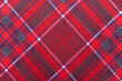 © Gudman - The texture of linen fabric in a large cage of red, blue and white. Scottish tailoring material. Checkered fabric