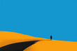© AnnaStills - Silhouette of young adult walking alone on sand dune under clear blue sky, figure casting long shadow on bright yellow sand, minimal landscape emphasizing solitary journey