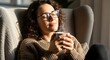 © Delip - Woman enjoying a quiet moment with coffee in a cozy chair