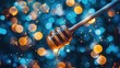 © mlangsen - Golden honey dripping from wooden dipper, blurred bokeh lights