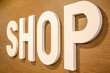 © Stefano Tammaro - Closeup of the Shop sign in large white letters on a wooden wall.