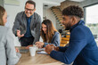 © Miljan Živković - Diverse business team collaborating during a corporate meeting