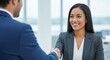 © ANDREY PROFOTO - Smiling diverse businesswoman shakes hands with male colleague in office