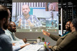 © DC Studio - Employees team engaging in strategic planning in a boardroom briefing late at night, using virtual communication via internet with shareholders to establish proposals that ensure success.