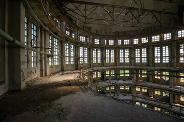  Abandoned distillery tower in Italy – circular industrial building with glass dome, steel beams, panoramic windows, decaying factory interior, urban exploration, post-industrial architecture