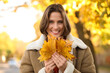 © Pixel-Shot - Beautiful young happy woman with fall leaves in autumn park