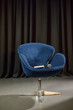 © Seventyfour - Empty modern chair standing on stage with closed notebook and microphone resting on seat, dark curtain background suggesting preparation for upcoming presentation or interview
