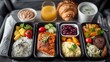 © Crocodilchik - Economy class meal on airplane tray, top-down view in sharp focus