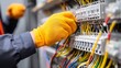 © admin_design - Skilled individual in protective gloves performing electrical switch maintenance and connection work.