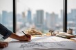 © Patrick Louvet - Architect sketching blueprints at a modern office desk with city skyline in background