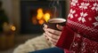© ArtStock - A cozy winter scene featuring a person holding a steaming mug of hot chocolate in front of a warm fireplace, creating a festive and inviting atmosphere