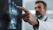 © Thares2020 - A medical professional points at a detailed X ray of a human foot highlighting bone structure and joints