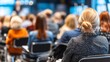 © gundo850 - Female Attendee Observing Conference Presentation in Modern Venue