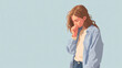 © Катерина Крюгер - A young Caucasian woman with long brown hair stands with her head down, wearing a light blue shirt and jeans. She appears contemplative and introspective.