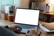 © NAMPIX - Close-up of a man working on a laptop with a blank white screen mockup, ideal for demonstrating websites or applications in a modern home office setting.
