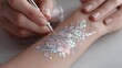 © Di Studio - woman painting glitter tattoo on child's hand