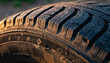 © jambulart - Close-up of a worn cracked tire tread with golden light.