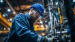 © Rifqi - Bearded factory worker in blue hard hat inspecting machinery and wearing safety glasses, concept for quality control, mechanical engineering and industrial innovation