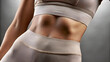 © utaem2022 - Close up of fit woman showing sculpted abs and toned physique