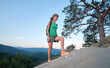 © bilanol - Young woman climbing alone on rocky mountain path. Female hiker enjoying difficult challenge on wilderness trail. Active way of life concept