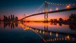 © YiXiong - Suspension bridge illuminated at sunset reflecting on river.