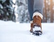 © gurem - Feet wearing brown boots walking forward in snowy, wintry terrain