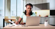 © Andrey Popov - Professional African American Woman Attends Online Webinar