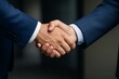 © diproduction - Close-up of business handshake between two people in formal suits representing agreement and partnership in a corporate lifestyle setting. Ai generative