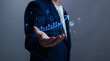 © PB Studio Photo - Businessman holding a growing bar chart with upward arrows, symbolizing financial growth, business success, data analytics, positive performance, marketing results and digital strategy