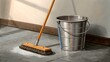 © Володимир Виповський - Sweeping floor in a bright room with a bucket nearby during daytime cleaning routine