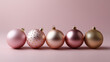 © Helga - This image showcases a minimalist and elegant Christmas composition, featuring six pastel pink and rose-gold ornaments arranged neatly in a row against a soft pink background. Each