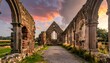 © Bismillah - Interior view of weathered stone ruins of an ancient structure under a colorful sunset sky. A path leads towards the end