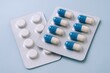 © The Little Hut - Pharmaceutical Pills and Capsules in Blister Packs, Healthcare Medication for Treatment, Disease Prevention on Blue Background
