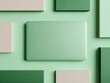 © Tanakrit - A sleek, mint-green laptop is surrounded by various pastel-colored rectangles on a soft green background, creating a modern and minimalist aesthetic.