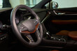 © Евгений Вершинин - Closeup of a modern car steering wheel with control buttons for technology and convenience