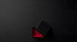© Ridho Satriawan - A black gift box with a red satin lining is open on a dark surface.