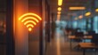 © Jdgkxbnc - Glowing orange wifi signal symbol on an office wall with blurred modern workspace background and warm ambient lighting