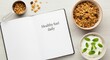 © Pixelia - Open diary on a table with healthy granola ingredients and text about daily fuel