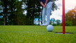 © somchai - Golf ball is on a green lawn in a beautiful golf course with morning sunshine.