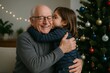 © diproduction - Grandfather hugging and smiling as granddaughter kisses his cheek near Christmas tree with ornaments and festive lights in cozy home setting. Ai generative