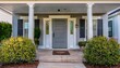 © Amy - elegant home entrance with grey door white pillars shutters and landscaped greenery