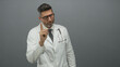 © Krakenimages.com - Man doctor pointing finger with stethoscope, raised index finger in grey studio; medical authority warning.