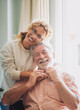 © luciano - Senior man smiles warmly as his daughter tenderly embraces him. The scene captures tenderness, affection, and emotional connection, symbolizing affection, care, and companionship in adulthood.