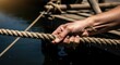 © photoplotnikov - Male hand gripping wet rope with dock background