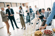 © deagreez - Group of diverse professionals collaborating and discussing during a corporate business meeting in a modern office space