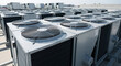 © Vasiliy - Multiple industrial HVAC air conditioning units on a rooftop. Rows of large cooling system fans for commercial building climate control